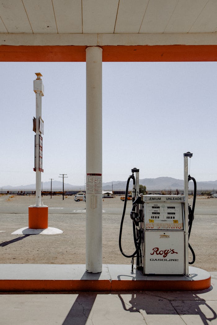 Classic gas station pump with a retro charm in a desert setting under bright daylight.